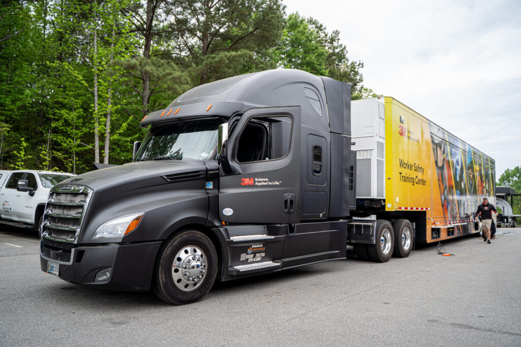 Semi truck with a large graphic displayed on the side.